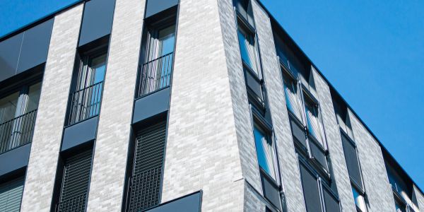 Modern building facade with windows and blue sky.