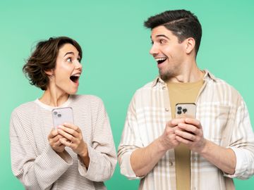 A man and woman looking at their phones.