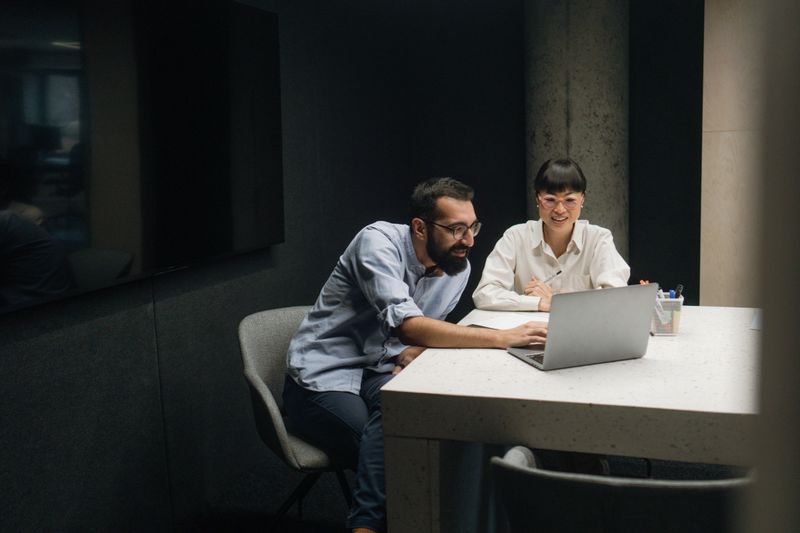Photo of an Asian woman attending a meeting with her coworker