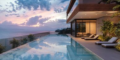 Modern villa with infinity pool overlooking ocean at sunset.
