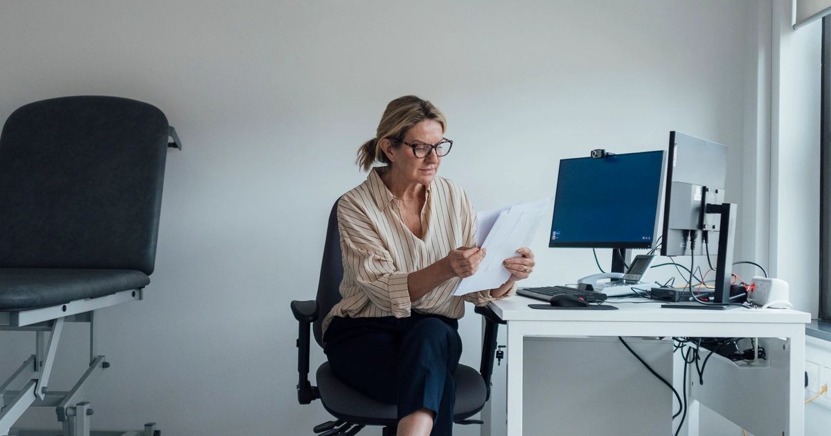 Stressed homeowner reviewing overdue mortgage bills and past due notices
