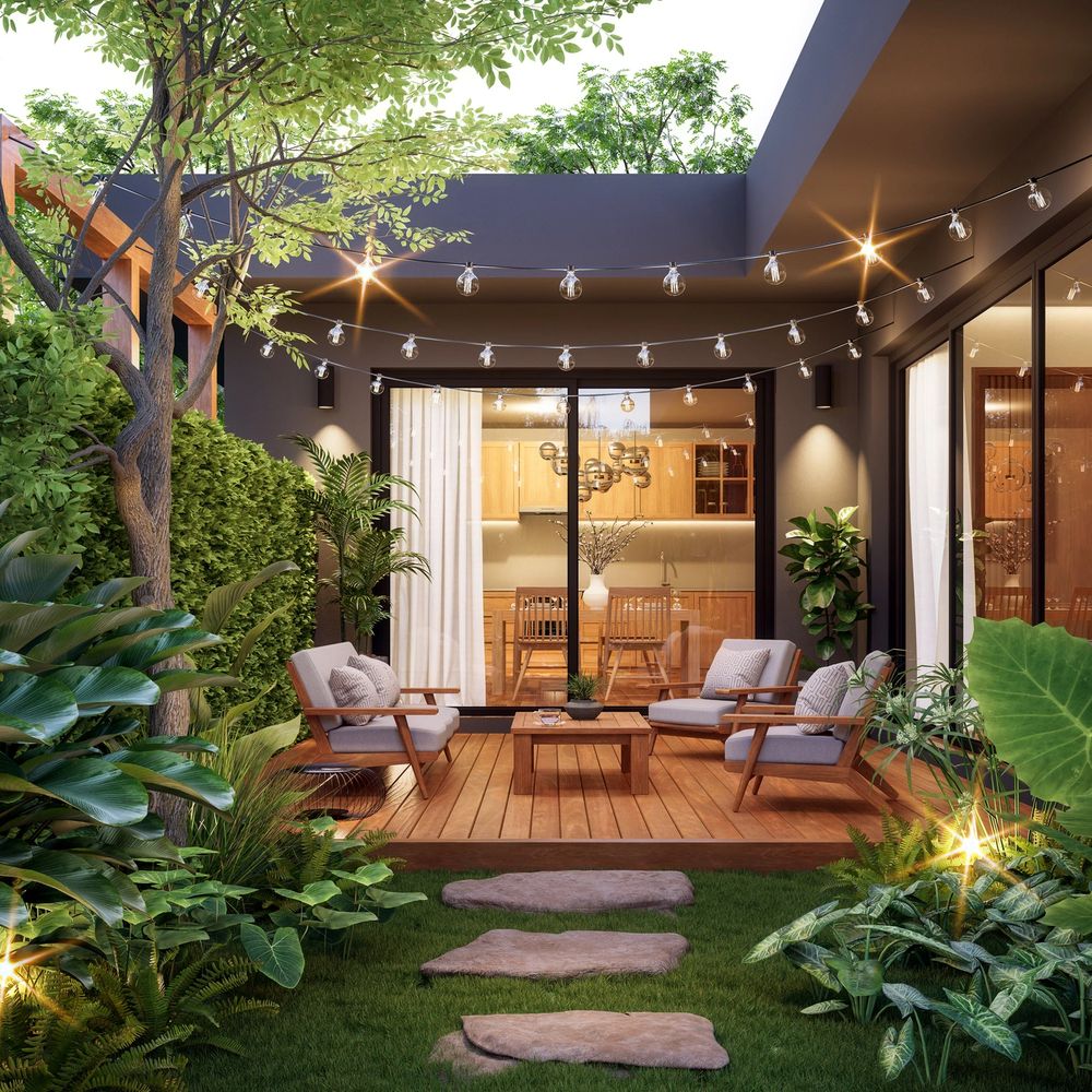 Cozy outdoor patio with string lights and lush greenery surrounding a wooden deck seating area.
