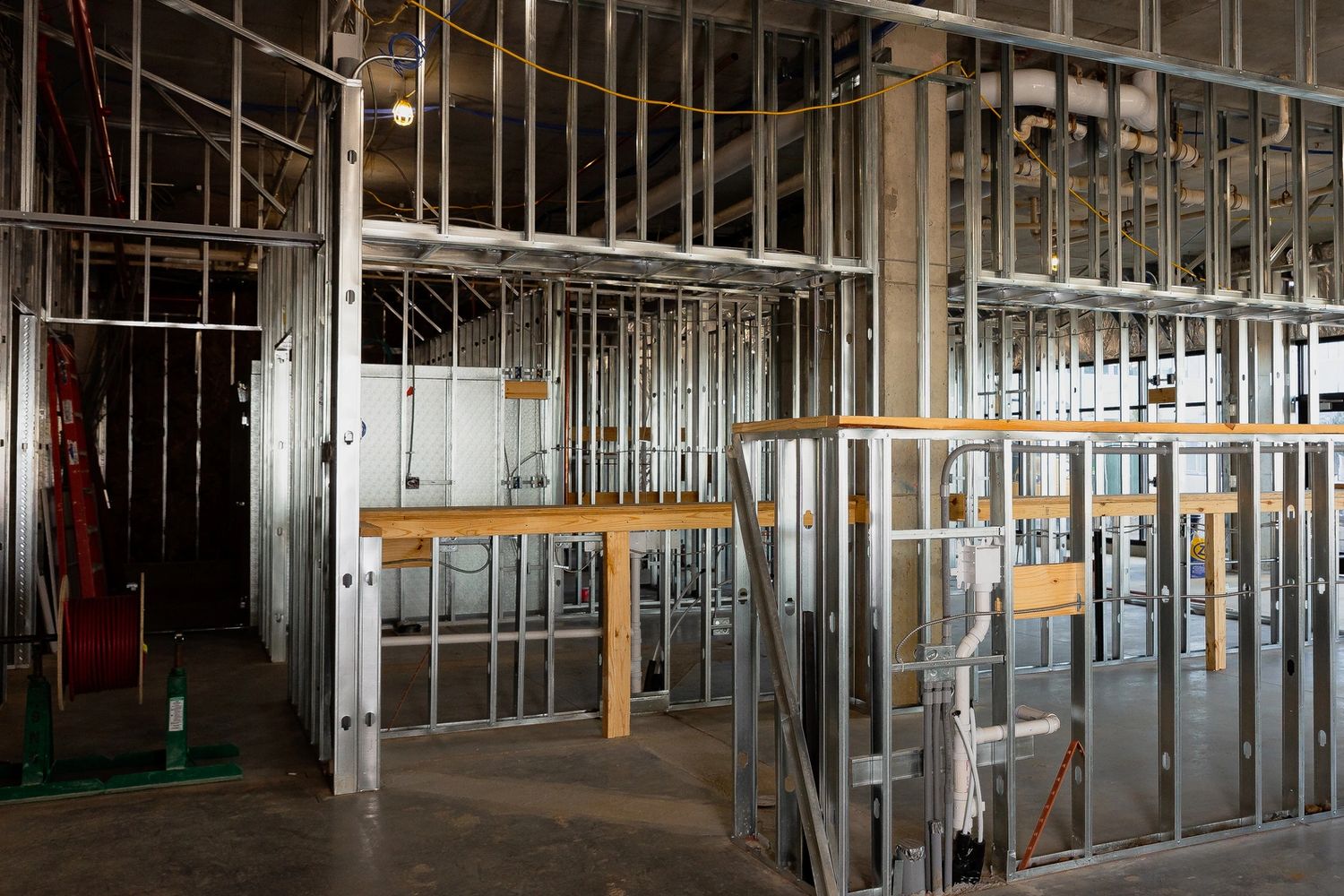 Stack of books next to pencils in a holder and a camera.