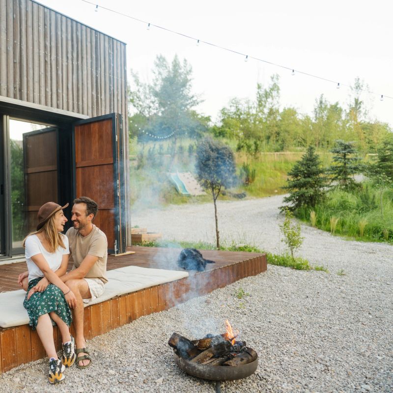 Photo of a loving couple, spending quality time together at the end of the busy week in front of their vacation home