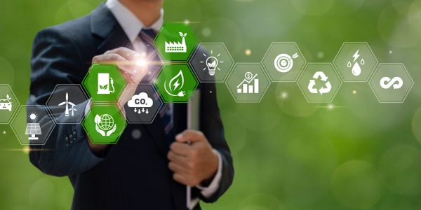 Businessman interacting with sustainability and green energy icons.