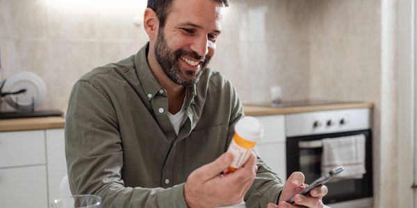 A vibrant sunset over the ocean, with silhouettes of palm trees and colorful clouds.