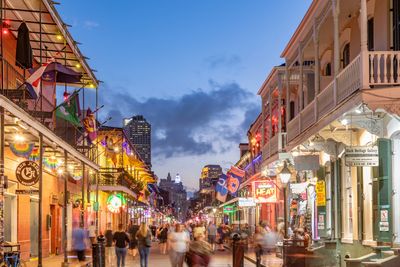 Photo  of a lit street with people walking.