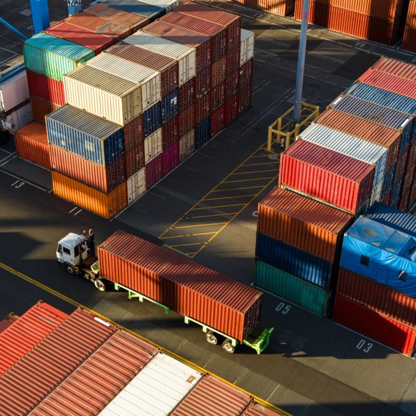 Cargo containers and a truck at a shipping yard.