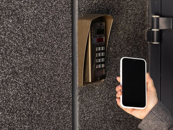 A smartphone unlocking a secure access control system, enabling keyless entry for modern security