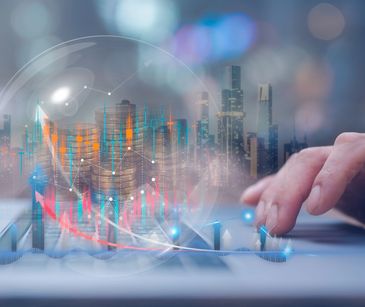 Hand interacting with digital financial charts and coins overlay on cityscape.