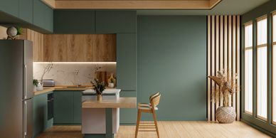 Modern green and wood kitchen with natural light and minimalistic decor.