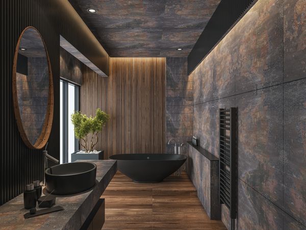 Modern luxury bathroom with black freestanding tub, wood slat walls, stone textures.