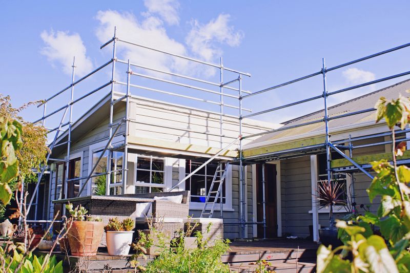 A house is surrounded by scaffolding as works take place on the rood.