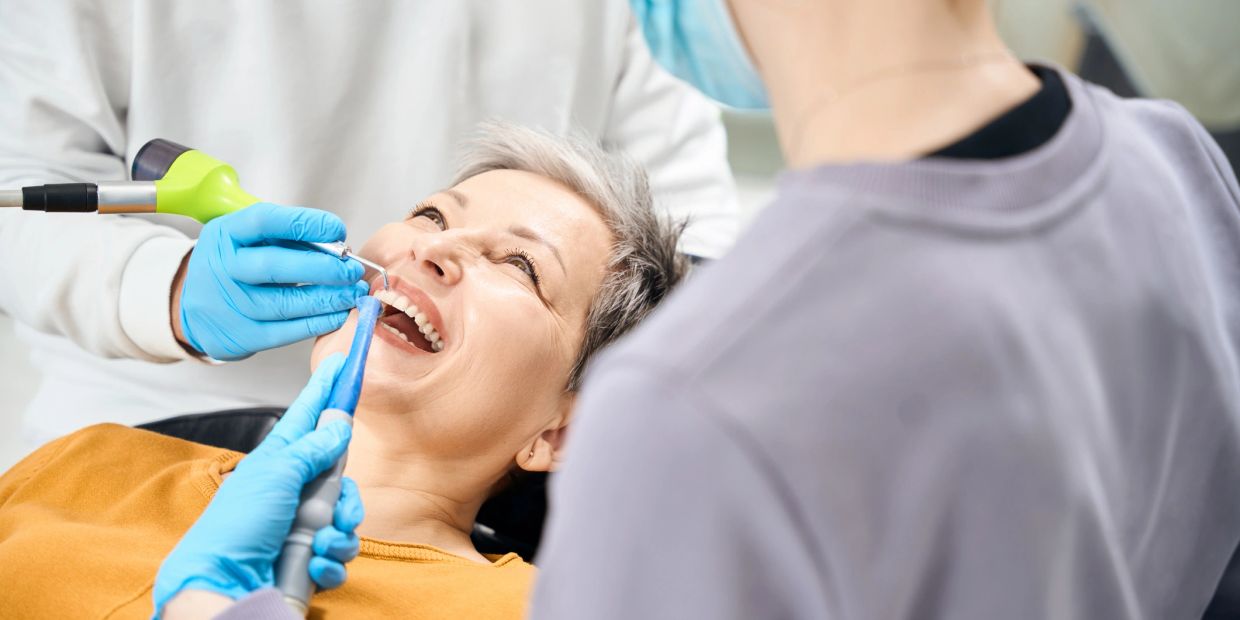 A woman smiling during a dental treatment.