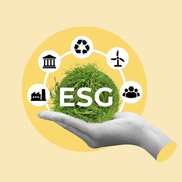 Hand holding a green sphere with ESG and sustainability icons around it.
