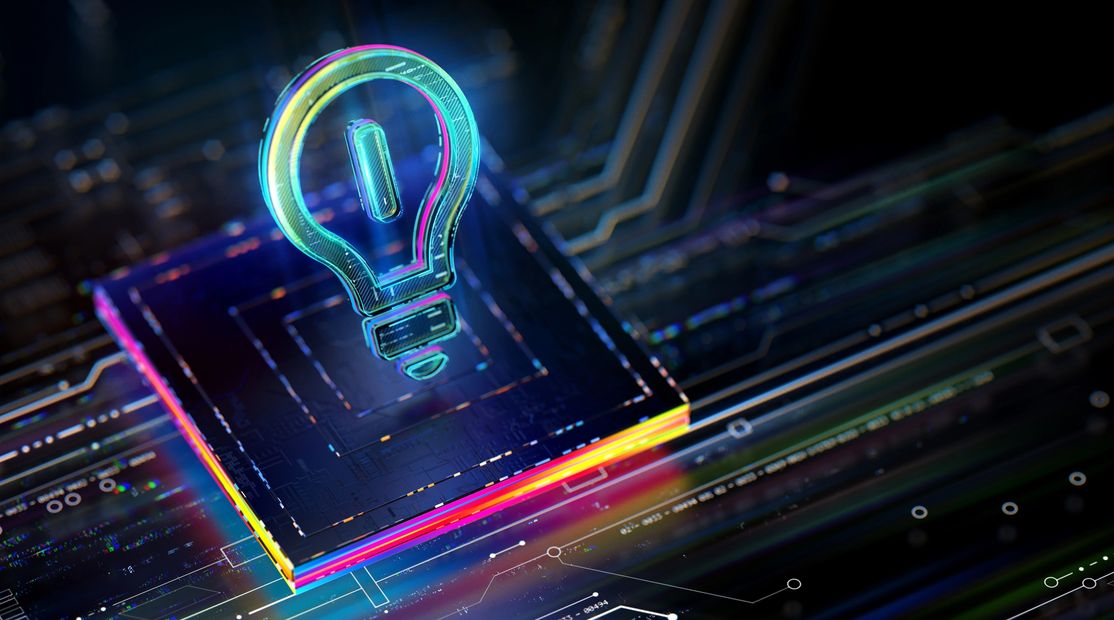 A glowing lightbulb icon above a colorful microchip on a circuit board.