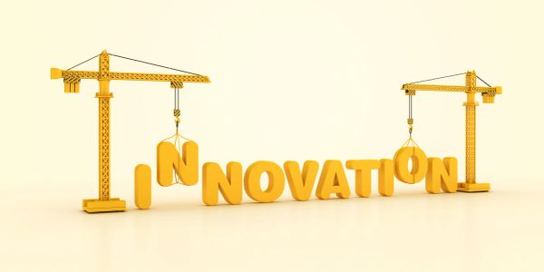 Cranes constructing the word 'INNOVATION'.