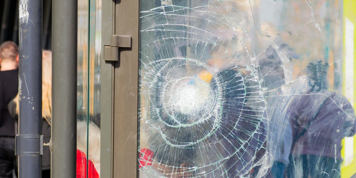 store front with a broken window and security film in salt lake city utah