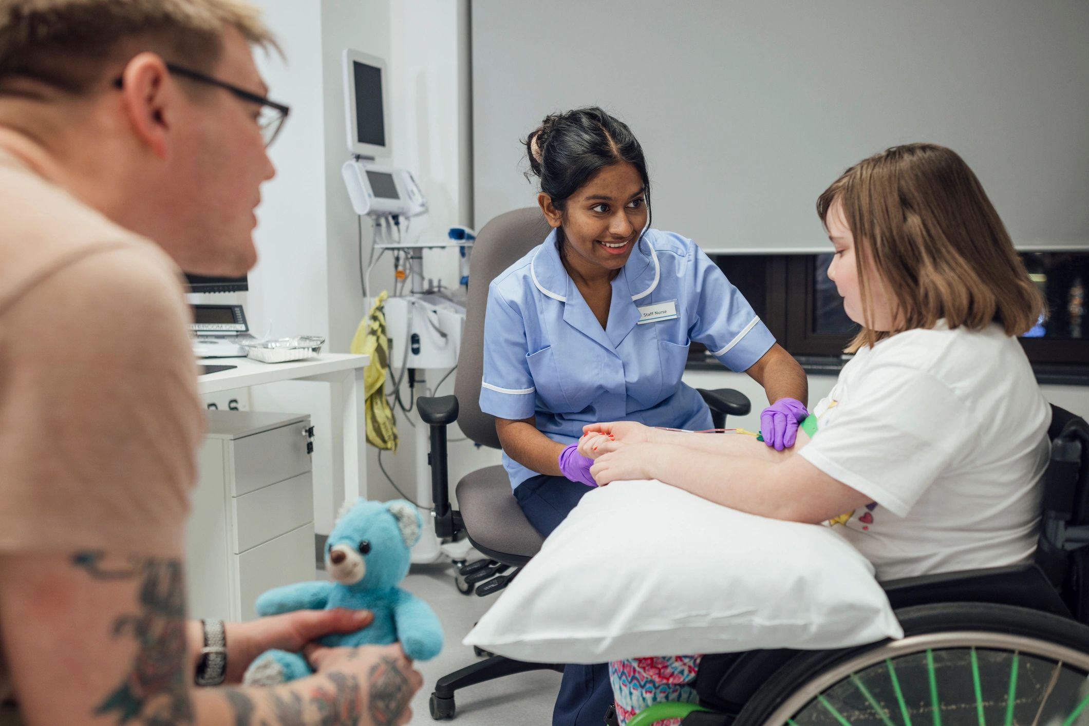 Healthcare professional drawing blood from a patient's arm with a needle.
