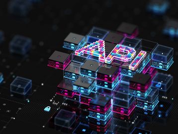 Colorful AI letters on futuristic digital blocks with neon lights.