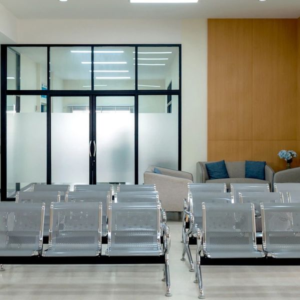 Modern waiting area with metal chairs and a cozy sofa set.