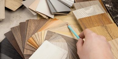 Person selecting wood laminate samples.