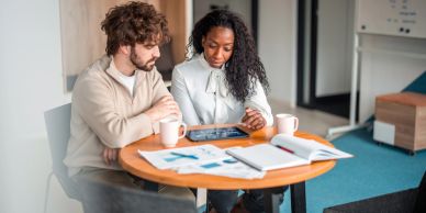 white male and African American female discussing business opportunity