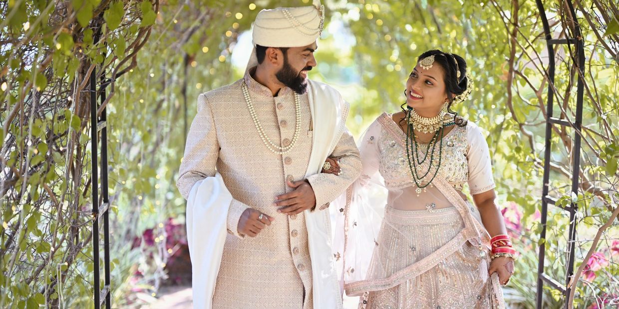A couple dressed in traditional Indian wedding attire.