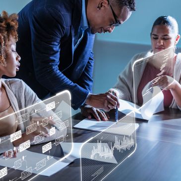 Business team collaborating with futuristic data holograms at a meeting.