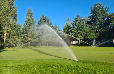 Lawn Irrigation sprinklers at work on a large section of turf.