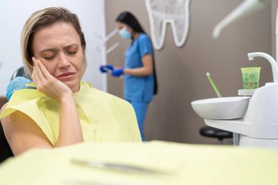 Patient with tooth pain sitting in the dental chair receiving same-day emergency treatment at Save D