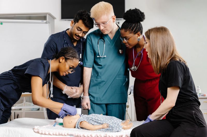 A group of doctors in professional attire standing attentively around a baby, likely conducting a medical examination or discussing treatment options.