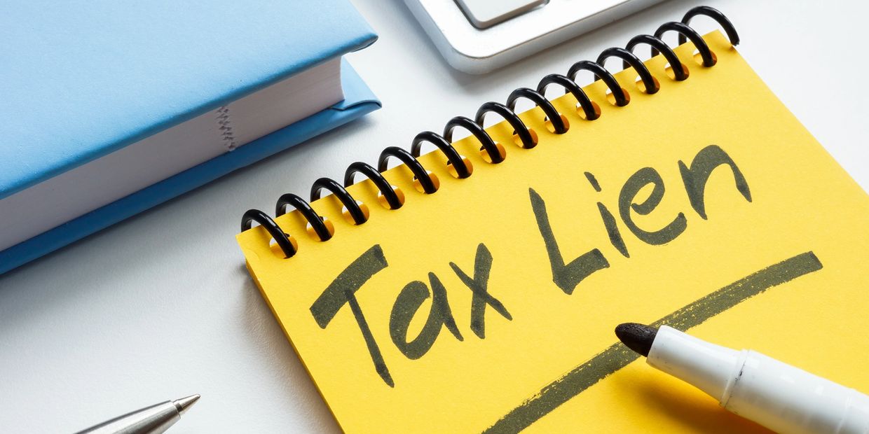 Notepad with 'Tax Lien' written on it.
