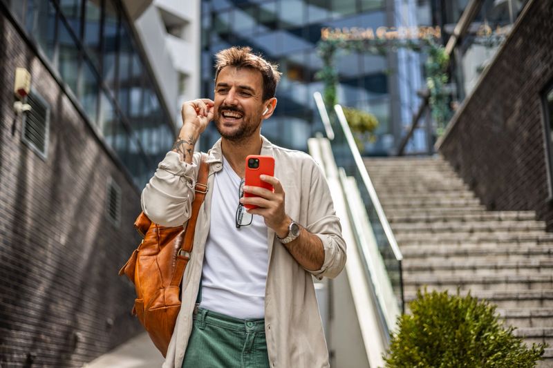 A man with a smartphone in his hand is talking through social media with his followers or family