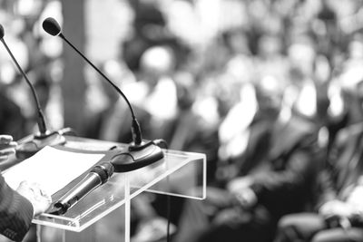 Microphones on a podium at a public speaking event.