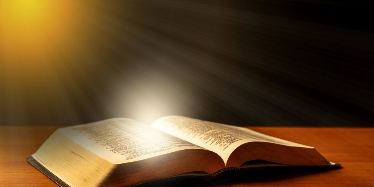 Open book with light shining on it.