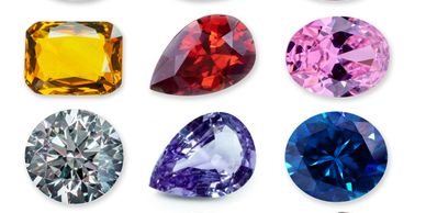 A collection of six colorful gemstones in various shapes and cuts.