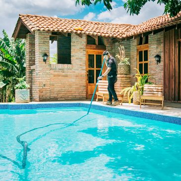 man cleaning swimming pool