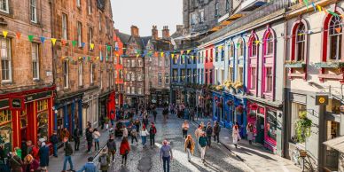Colorful street with people walking in a historic town.
