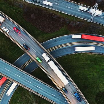 Aerial view of highways with trucks and cars.