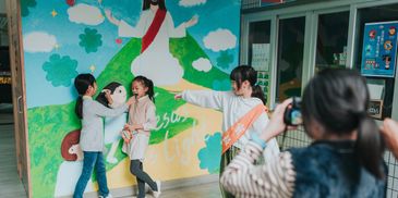 Happy children exploring and playing indoors.