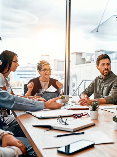 Team discussing ideas in a modern office meeting room.