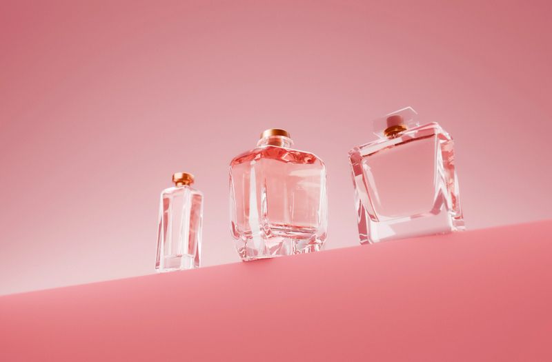 A product on display in a colorful studio environment. The beauty product on display is a glass perfume bottle with a luxury feeling. Created in 3D.