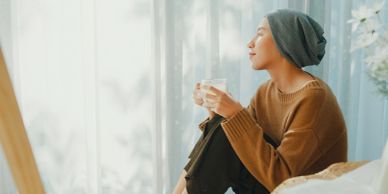 Woman hanging an open sign at her store.