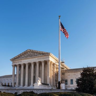 The photo shows a county office with the American Flag