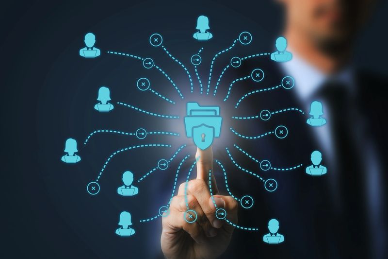 Close-up of a businessman's hand interacting with a cybersecurity network interface, symbolizing protected digital communication.