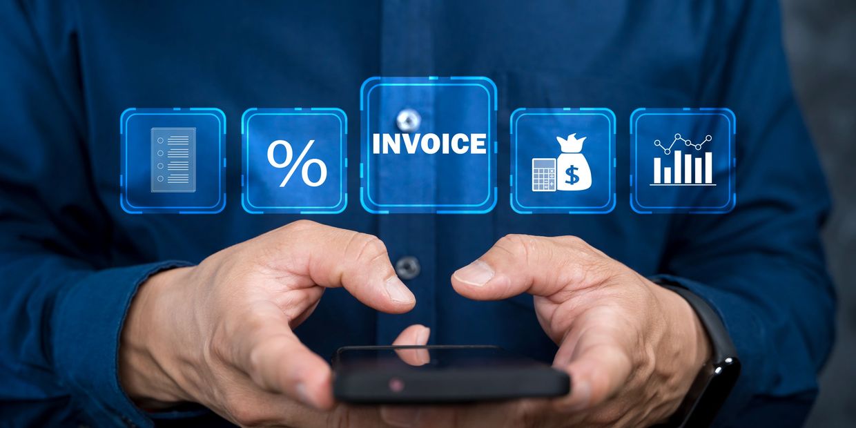 Person holding smartphone with digital invoice and financial icons floating above.
