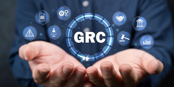 Hands presenting digital icons around GRC acronym symbolizing governance, risk, and compliance.