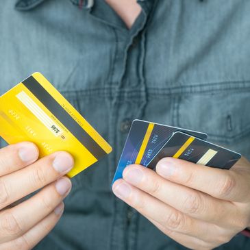 man holding credit cards
