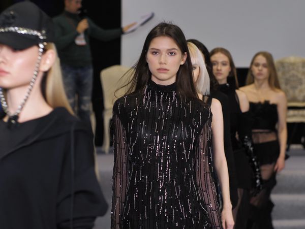 Models walking the runway showcasing black fashion designs.